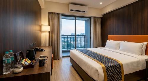 a hotel room with a bed and a large window at Royal Richmond Hotel in Dhaka
