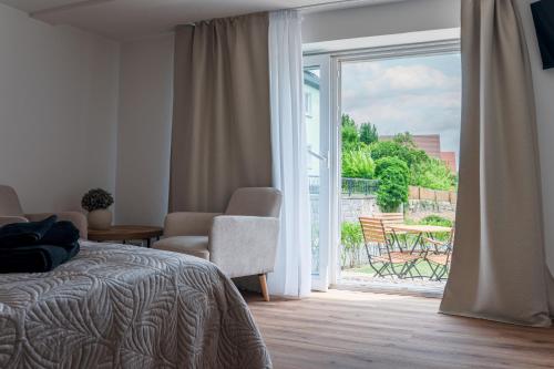 a bedroom with a bed and a sliding glass door at Elbsandsteinlodge in Sebnitz