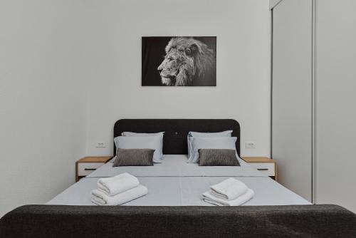a bedroom with a bed with a picture of a lion at Modern Studio Old Town by MN Property in Kotor