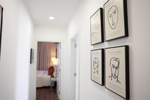 a hallway with four framed drawings on a wall at Casa Ferreira in Olaia