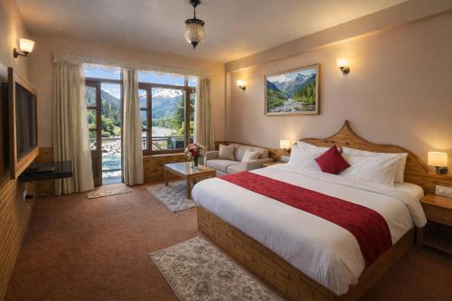 a hotel room with a bed and a television at Hotel Hollywood Vibes #riverview #premium rooms #prime location #most awarded #parking #top rated #open terrace #lawn #best selling hotel in manali in Manāli