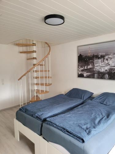 a bed in a room with a spiral staircase at Marktstube in Marsberg