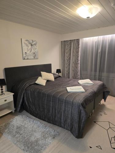 a bedroom with a bed with two towels on it at Ketunpesä Puijolla in Kuopio