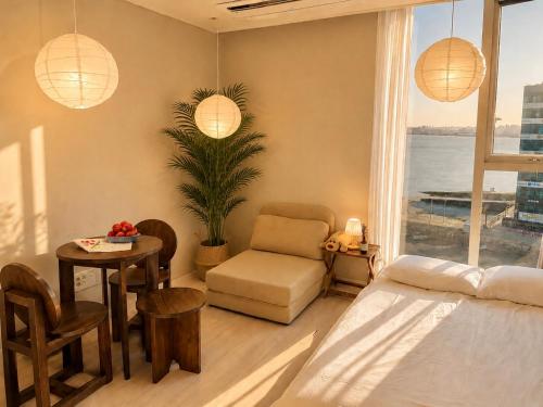 a bedroom with a bed and a table and a chair at Mood-Ocean 영종도 오션파크나인호텔 in Chagyak-to