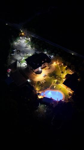 an overhead view of a pool at night with lights at Villa Aresini - Dimora Esclusiva in Montemiletto