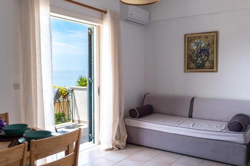 a room with a bed and a large window at Corfu Dream Holidays Villas Standarts in Glyfada