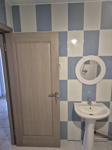 a bathroom with a toilet and a sink at Casă Bubu in Cacica