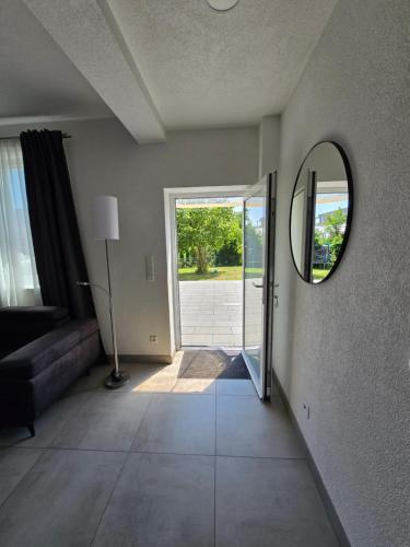 a living room with a mirror and a couch at FeWo Morgenstern in Bad Wildungen
