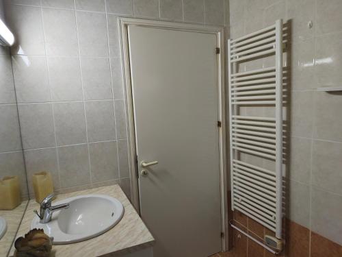 a bathroom with a sink and a white door at Greenfield House in Psevdhas