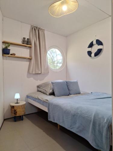 a bedroom with a bed with a soccer ball on the wall at Mazurska Chatka Pilchy in Pilchy