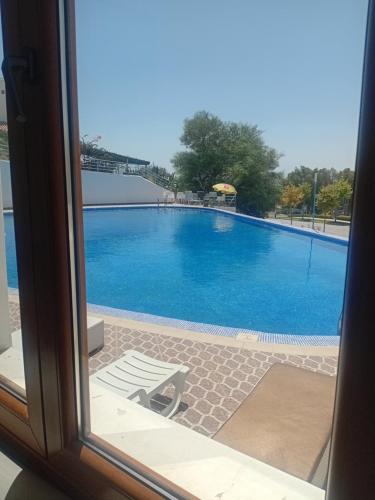 a view of a swimming pool through a window at Appart-Hotel Cabodream beach in Tétouan