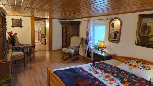 a bedroom with a bed and a table and a chair at Zacisze 13 in Leśna