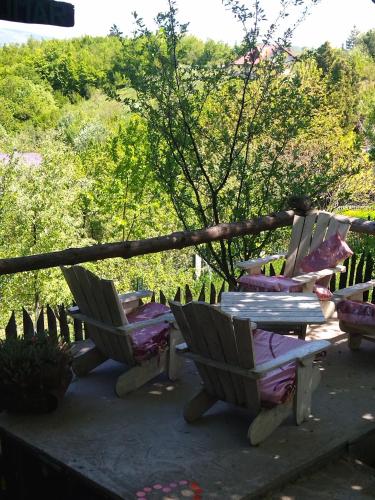 a couple of chairs and a table on a patio at Cabin Hill Station Queen in Sarajevo
