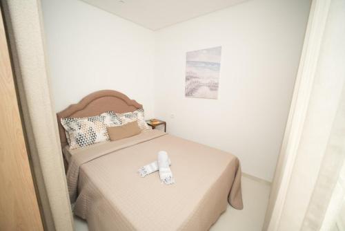 a small bedroom with a bed in a room at The Calm Coast Studio in Harqalah