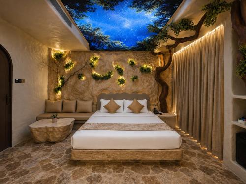 a bedroom with a bed with a tree mural on the ceiling at Dragonfly Hotel - The Art Hotel in Mumbai