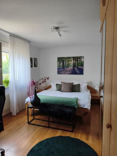 a bedroom with a bed with a vase on it at FeWo Sartorius am Hemsberg in Bensheim