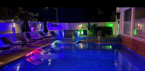 a swimming pool at night with colorful lights at Captivating Cottage in Provincetown