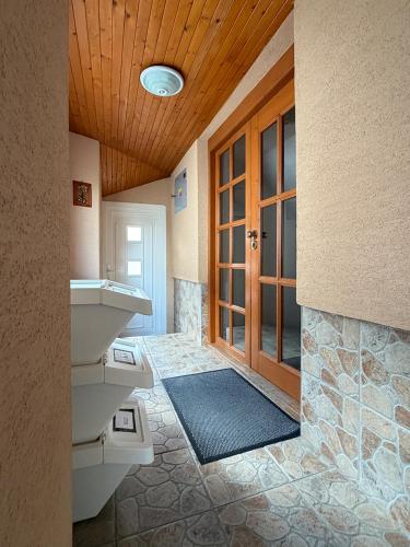 a bathroom with a sink and a wooden ceiling at Apartmány Hrady in Zuberec