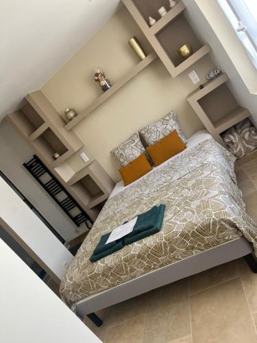 a bedroom with a bed with a green napkin on it at Douce escale in Le Crotoy