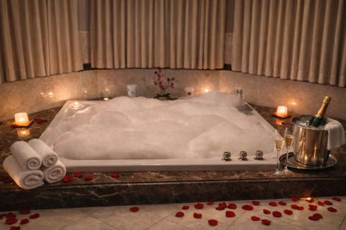 a bath tub with towels and candles in a bathroom at Whispering Oak Mansion in Bear