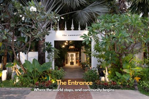 an entrance to a garden with trees and plants at The Community - Siem Reap in Siem Reap