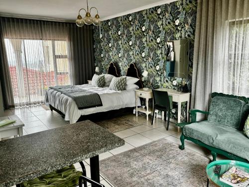 a bedroom with a bed and a table and a chair at Welgemoed Villa in Bellville