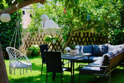 a patio with a couch and chairs and a table at Home Irianna in Marathon