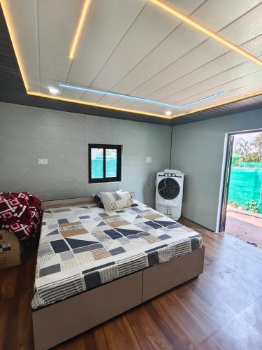 a bedroom with a large bed in a room at Himjoy farm in Dādo Sība