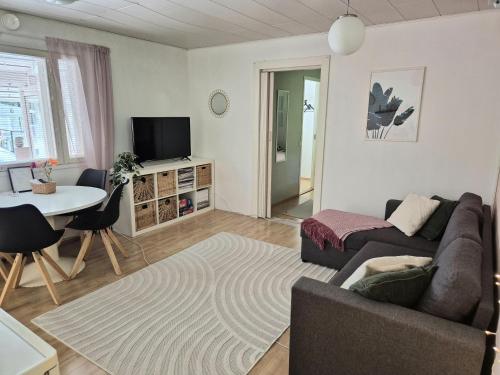 a living room with a couch and a table at Solmula in Keuruu