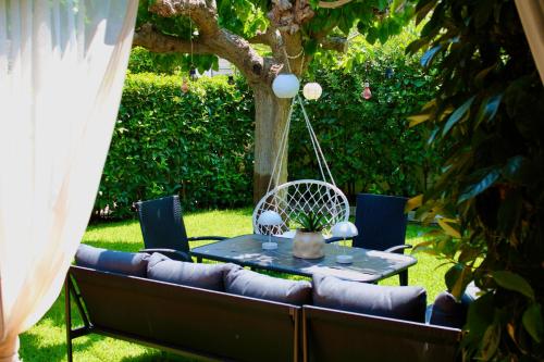 a table and a couch in a yard at Home Irianna in Marathon
