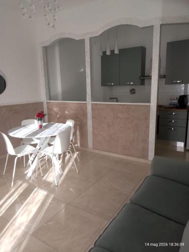 a living room with a table and chairs and a kitchen at Casa Manzoni 45 in Scandicci