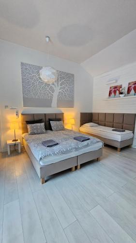 a bedroom with two beds and two lamps in it at Willa bankietowa z basenem in Papiernia