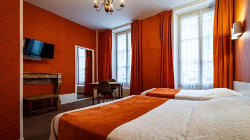 a hotel room with a bed and a fireplace at Hotel Du Nord in Besançon