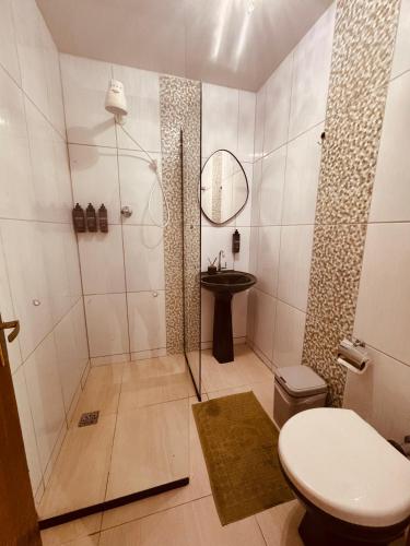a bathroom with a shower and a toilet and a sink at Office-Stay in Casimiro de Abreu