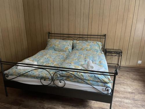 a bed in a bedroom with a bed frame with a blanket at Sam's Lakeview apartment in Ringgenberg