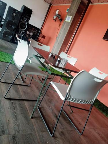 two chairs and a glass table in a room at Zim Zam View Hotel in Onitsha