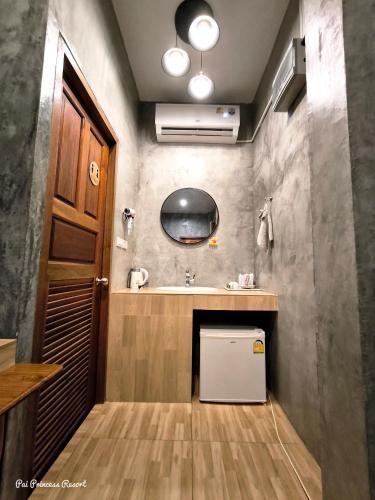 a small bathroom with a sink and a mirror at Pai Princess Resort in Pai