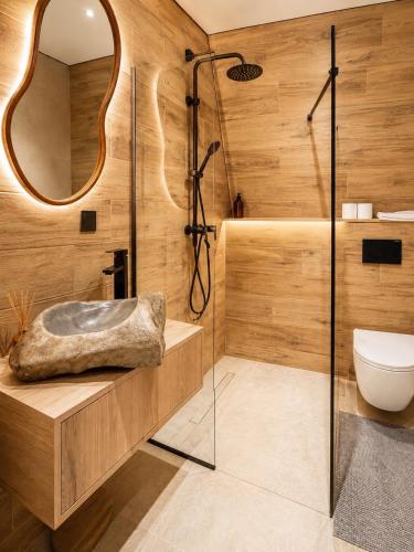 a bathroom with a shower and a sink at Dilok Hills in Mykulychyn