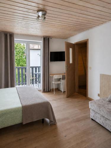 a bedroom with a bed and a sliding glass door at Willa Plażowa in Mielno