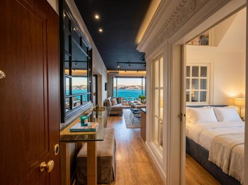 a bedroom with a bed and a view of the ocean at Alfred Promenade Apartments in Sarandë