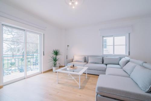 a living room with a couch and a table at Casa do Jardim in Olhão