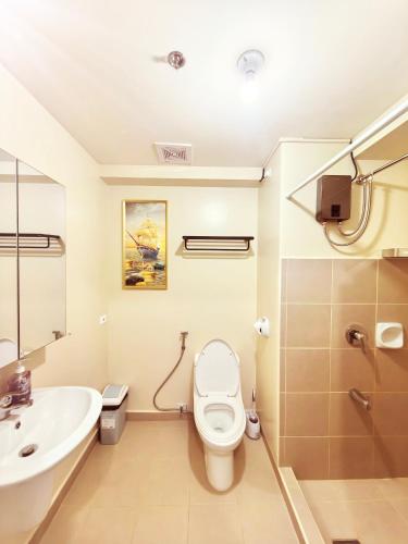 a bathroom with a toilet and a sink at New OneHeart Avida Riala T5 Condo in Cebu City