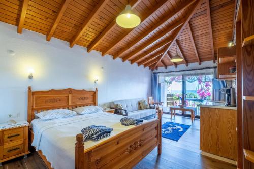 a bedroom with a bed and a living room at Liman Pansiyon Palamutbükü in Datca