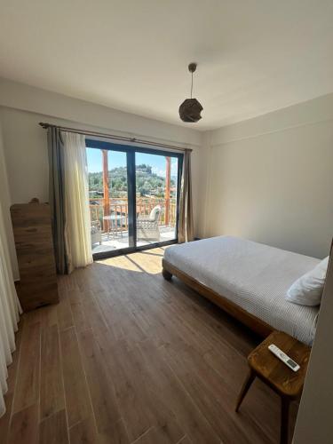 a bedroom with a bed and a sliding glass door at Villa Keyf Göcek in Fethiye