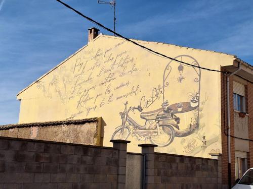 a mural on the side of a building with a motorcycle on it at CASA PITA Completa Grupos in San Justo de la Vega
