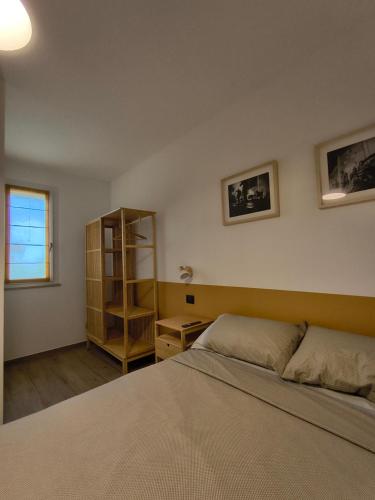 a bedroom with a bed and a book shelf at Agriturismo L'Olivastro in Pollutri
