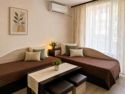 a bedroom with two beds and a window at Hotel Topalovi in Nesebar