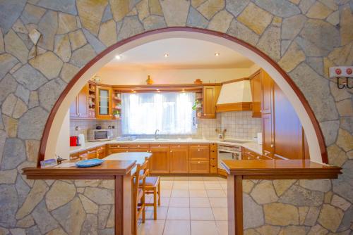 a kitchen with an archway in the middle of it at Paxos Santa Marina Villas in Gaios