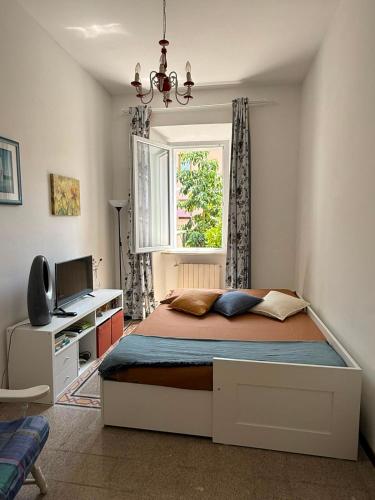 a bedroom with a bed and a desk and a window at Eden casa vacanze in Morlupo