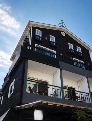 a black and white building with a balcony at Byeolbitdam Yangyang in Yangyang